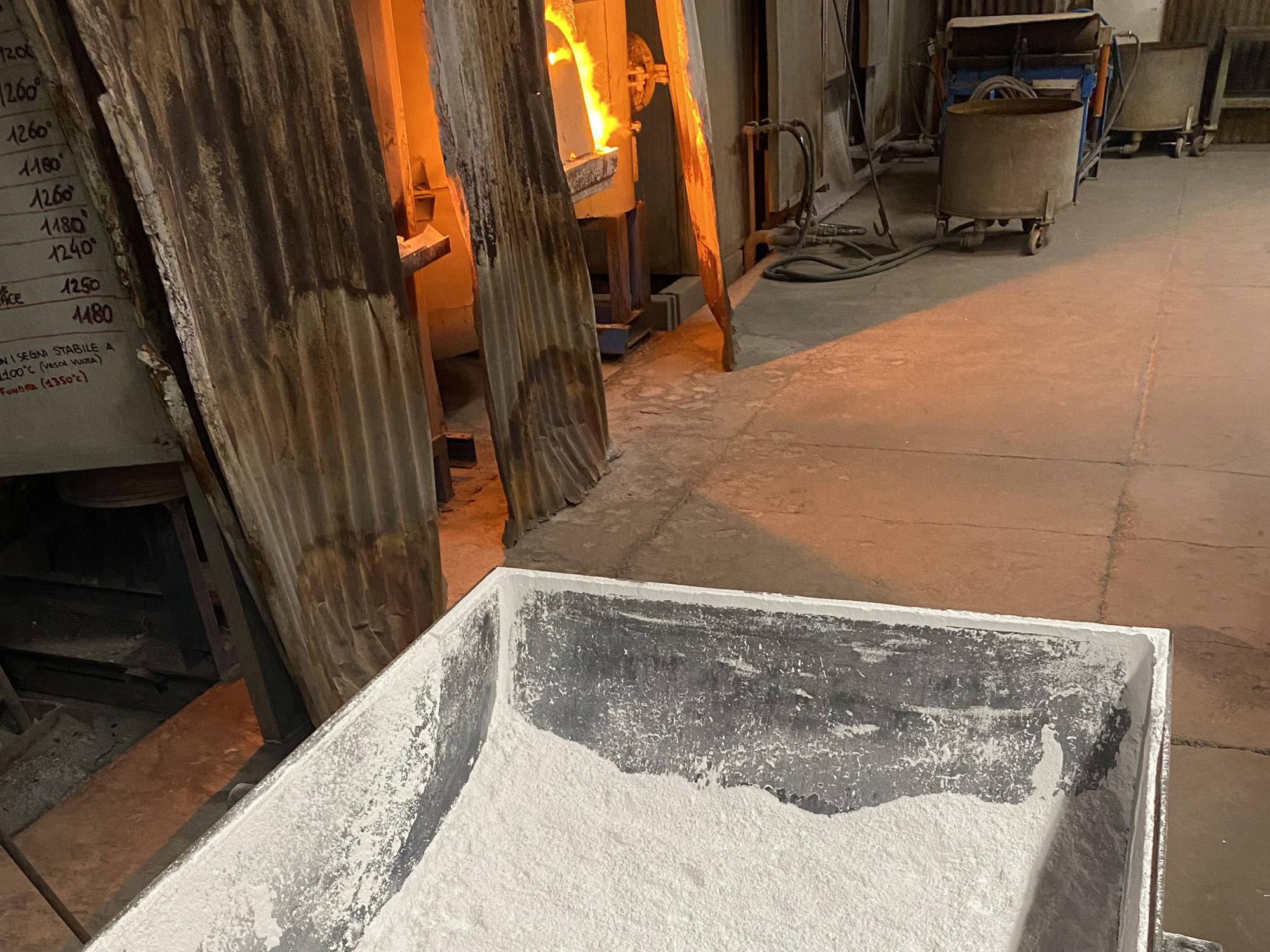 A tub full of white powder near a furnace