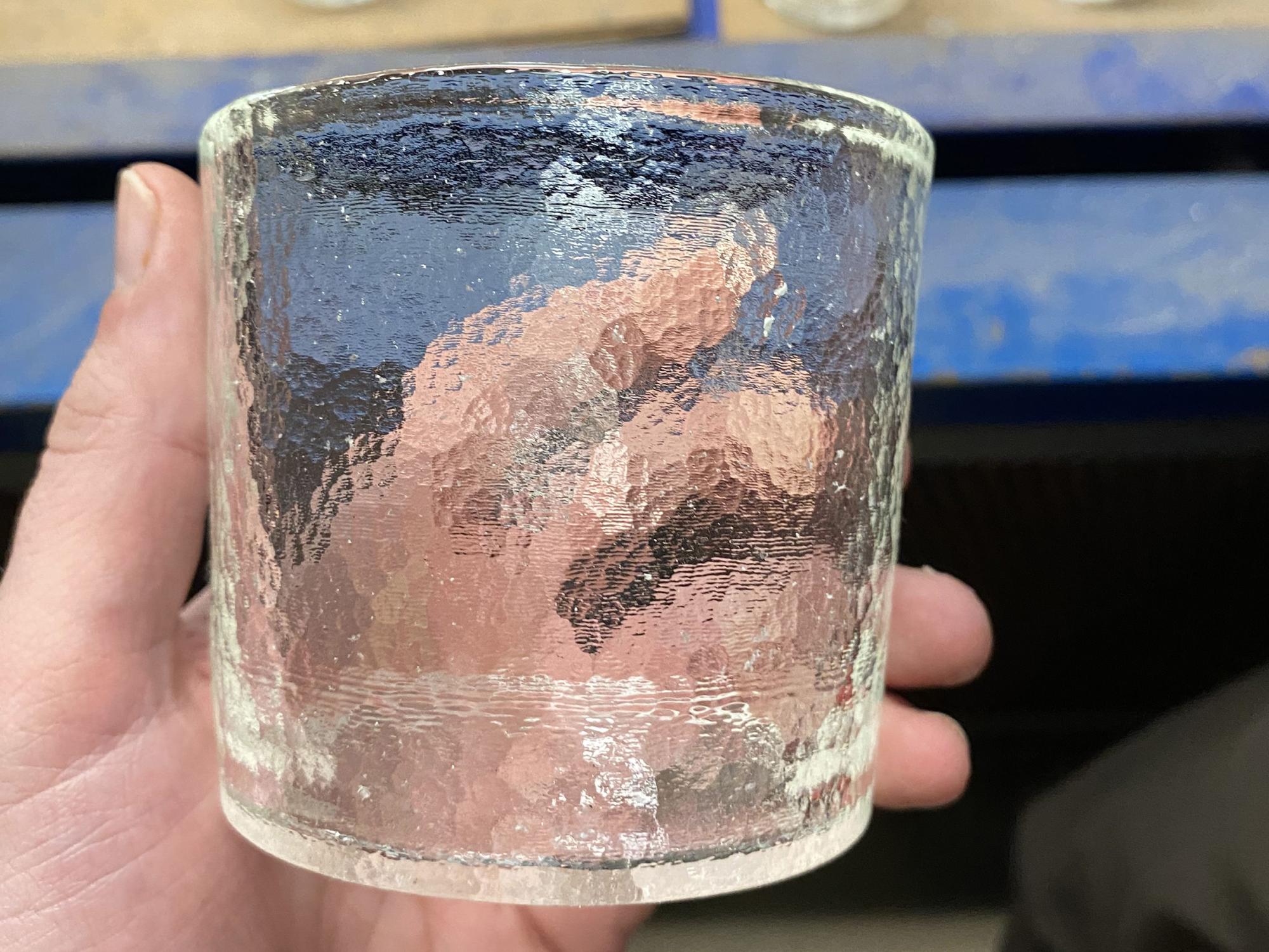 A hand holding a drinking glass