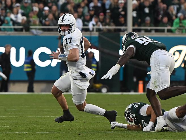 Quarterback runs away from defenders