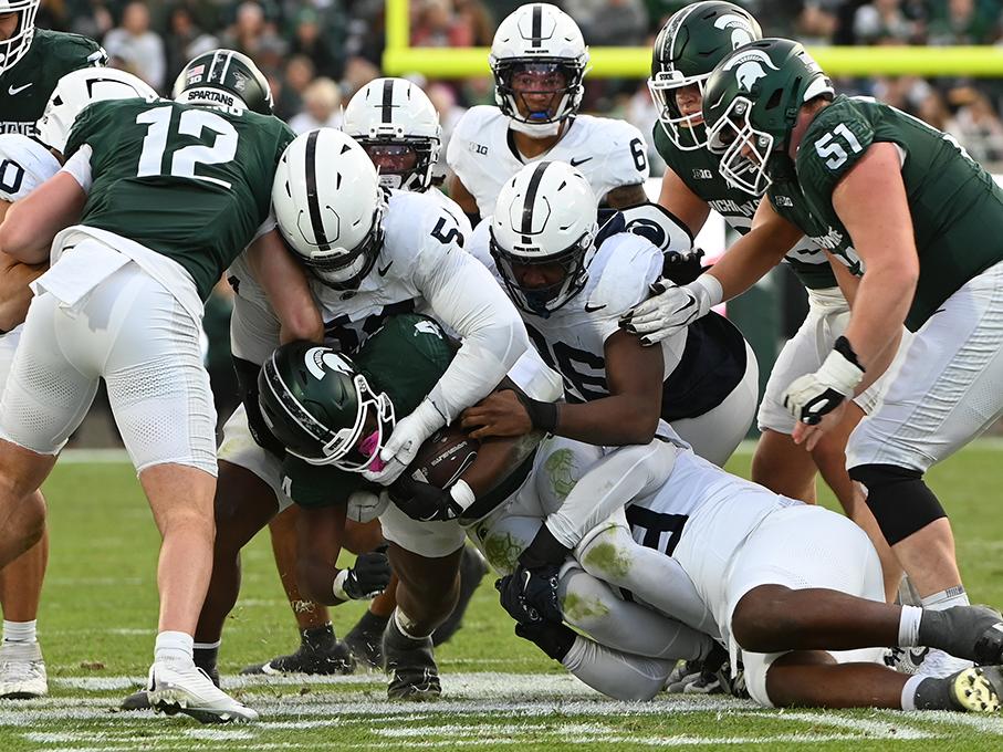 Penn State defenders tackle Michigan State runner