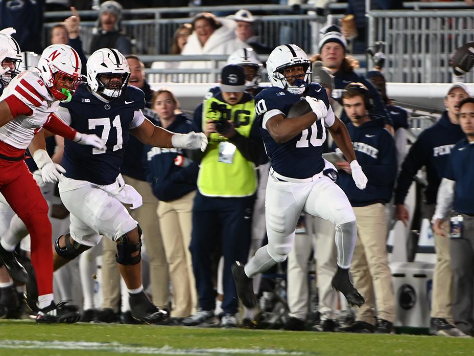 Football player running away from players