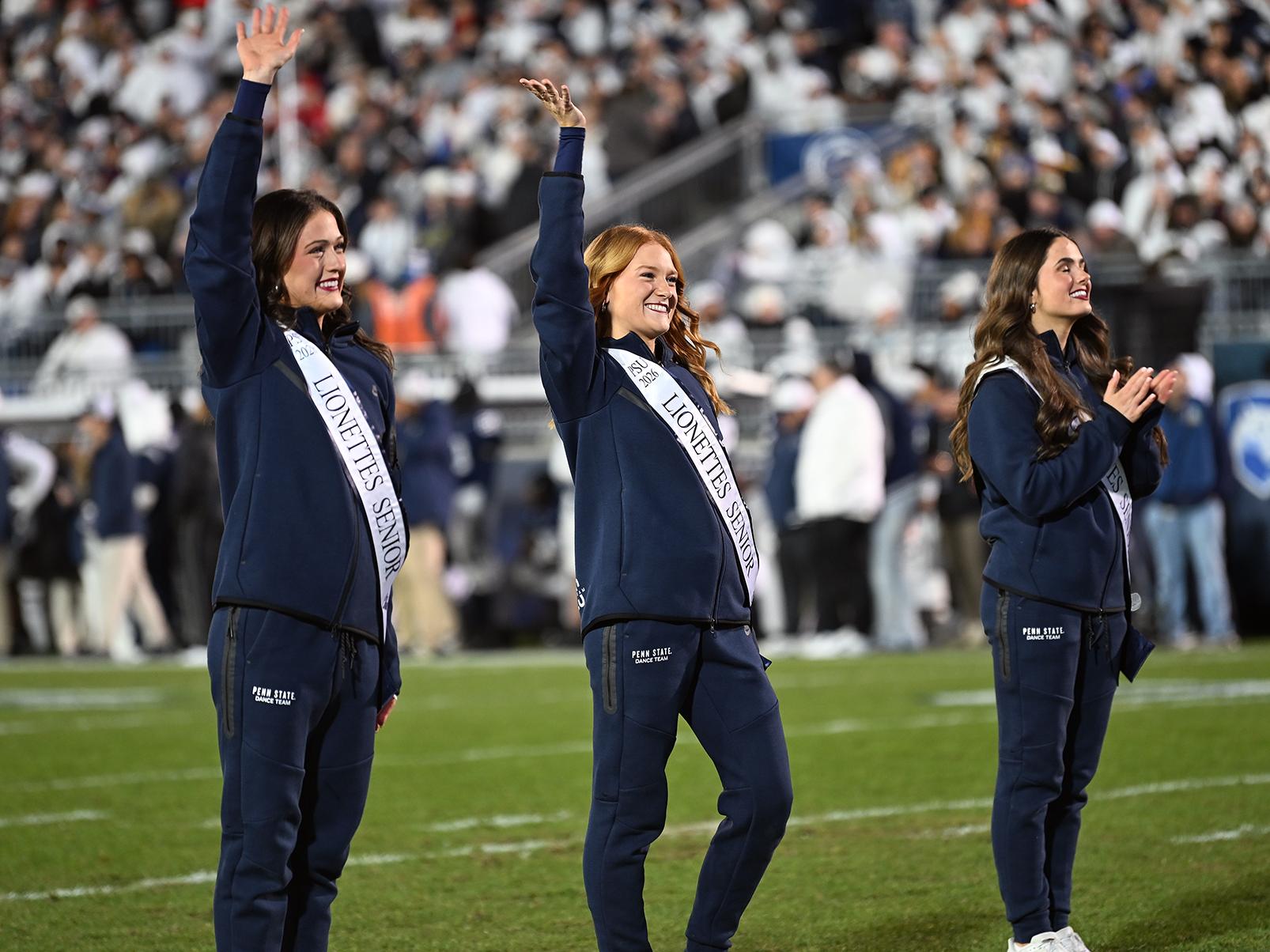 Dance team members waving