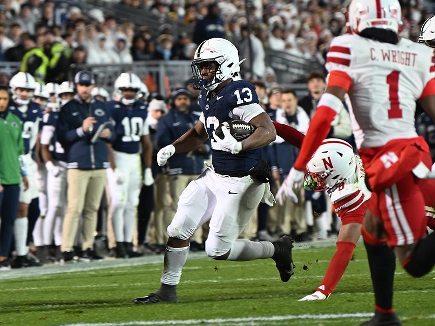 Football player runs through defenders