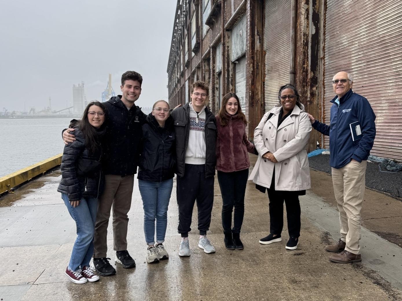 group of students standing next to the Delaware River