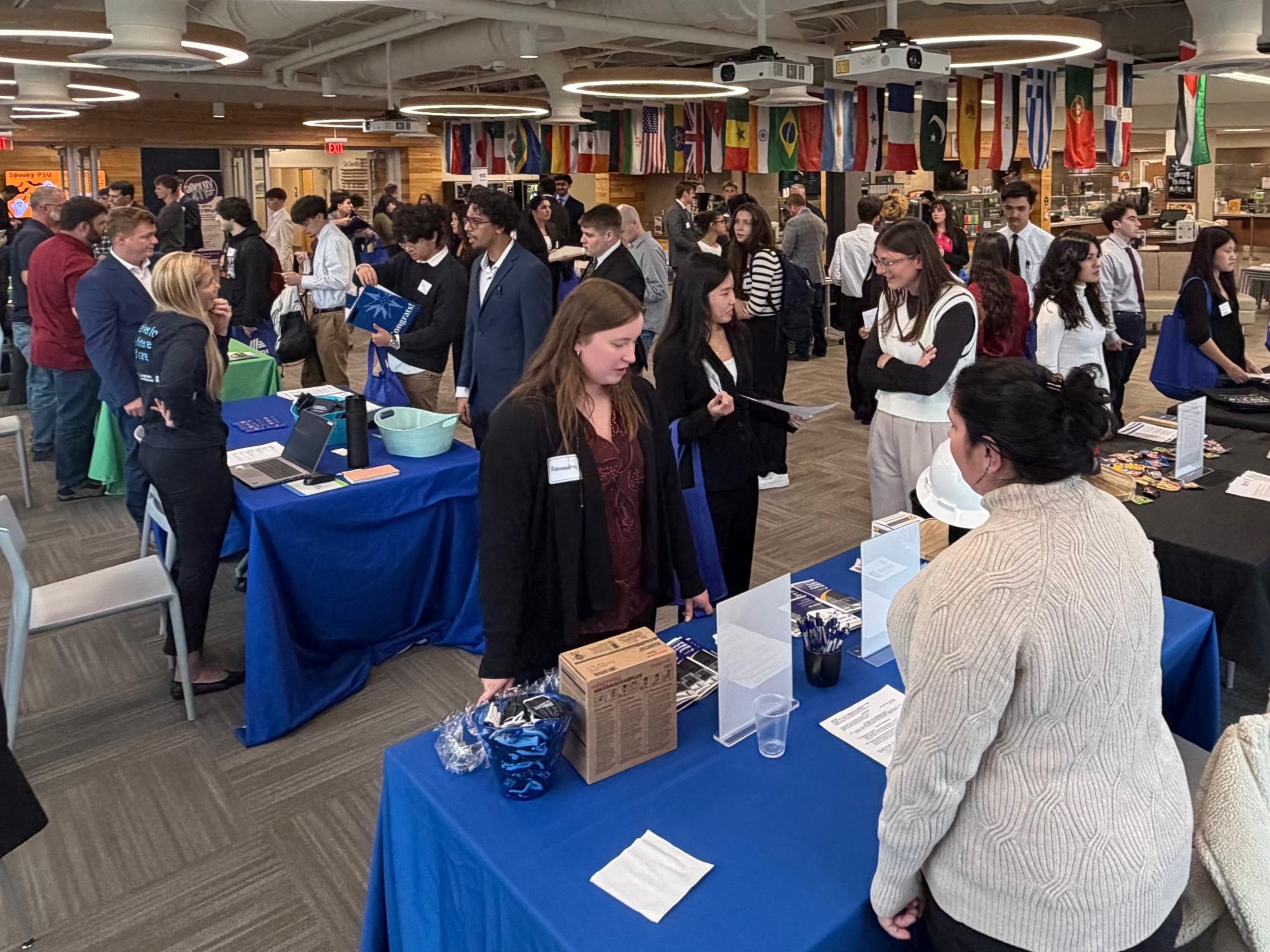 Penn State Lehigh Valley career fair with people standing at tables speaking to representatives