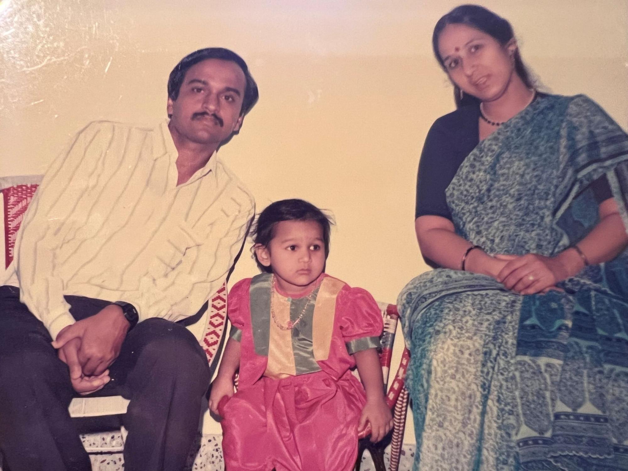 father and mother with toddler child
