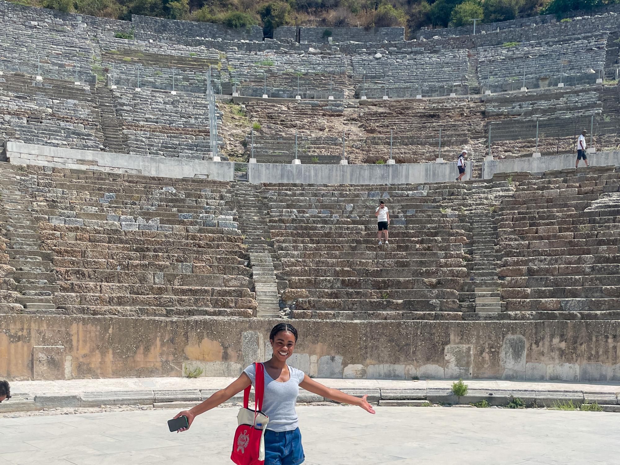 Simone Warren stands at the center of an amphitheater in Turkey.