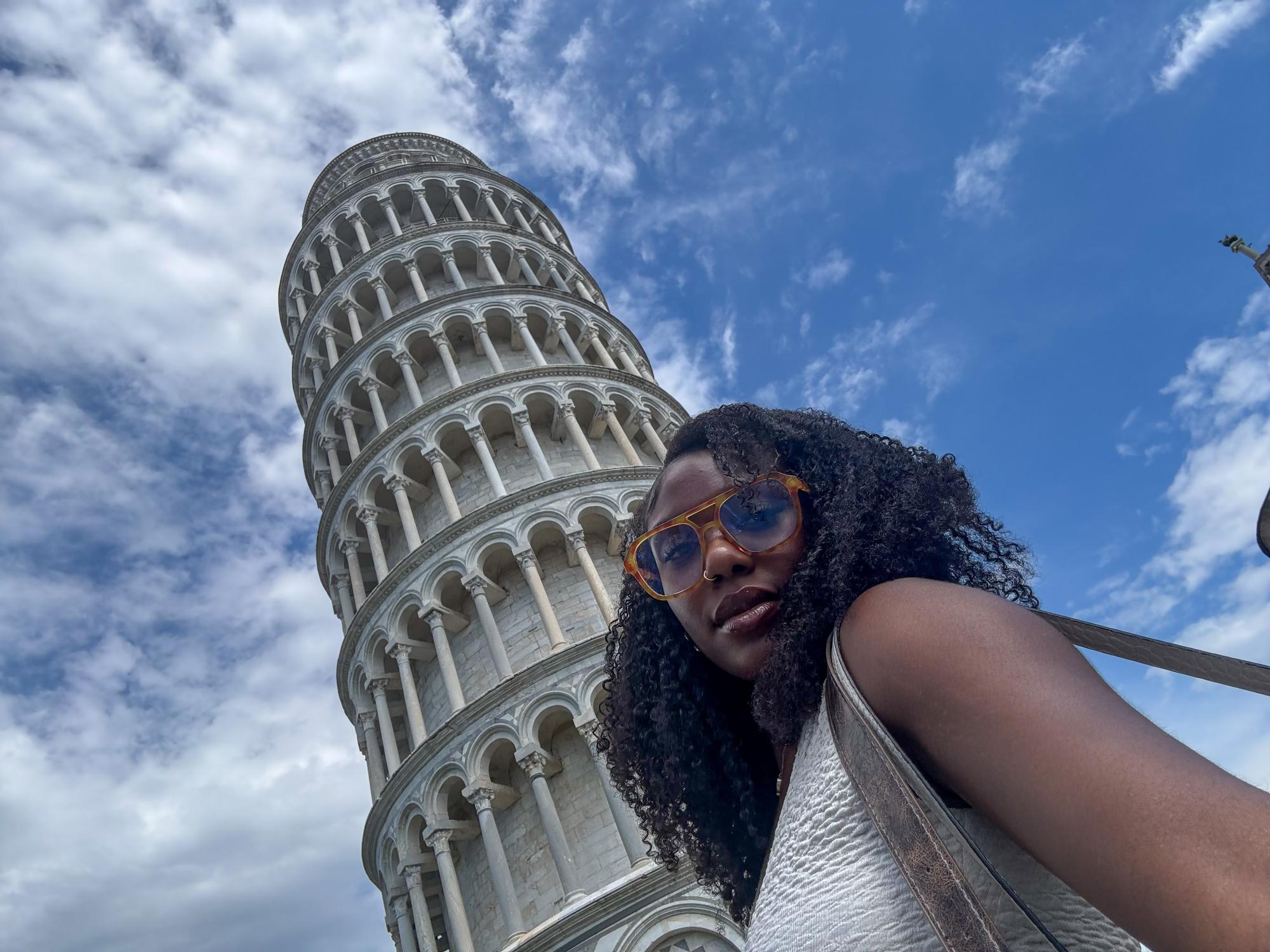 Camren Boyogueno posing near the Leaning Tower of Pisa.