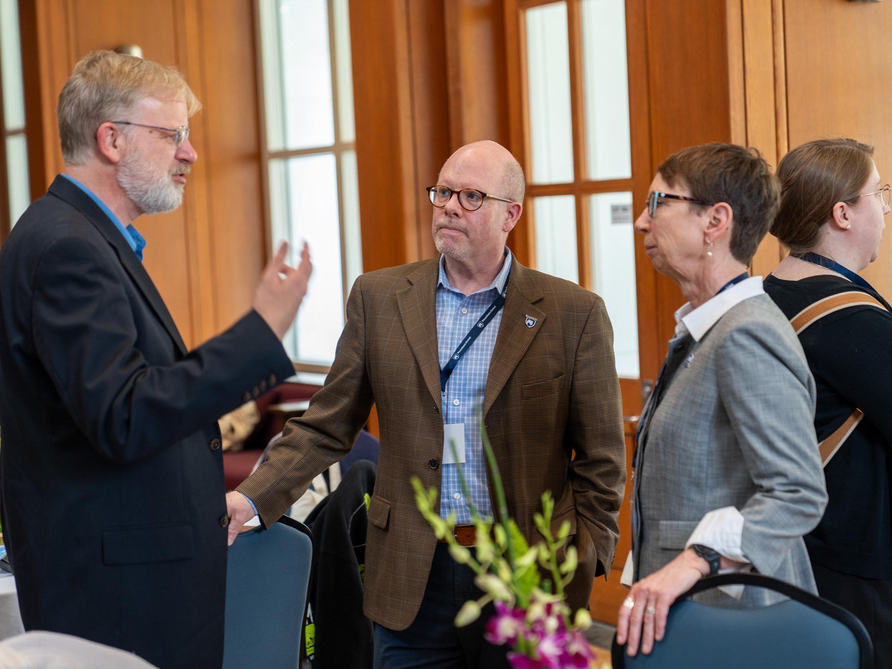 A man and a woman talking to another man