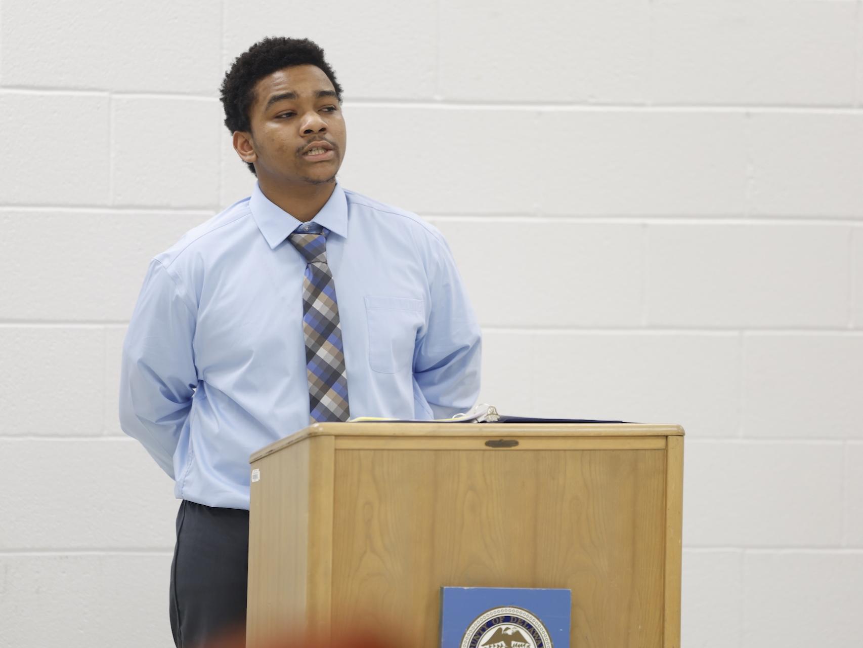 LaMont speaking behind a podium in the George W. Hill chapel.