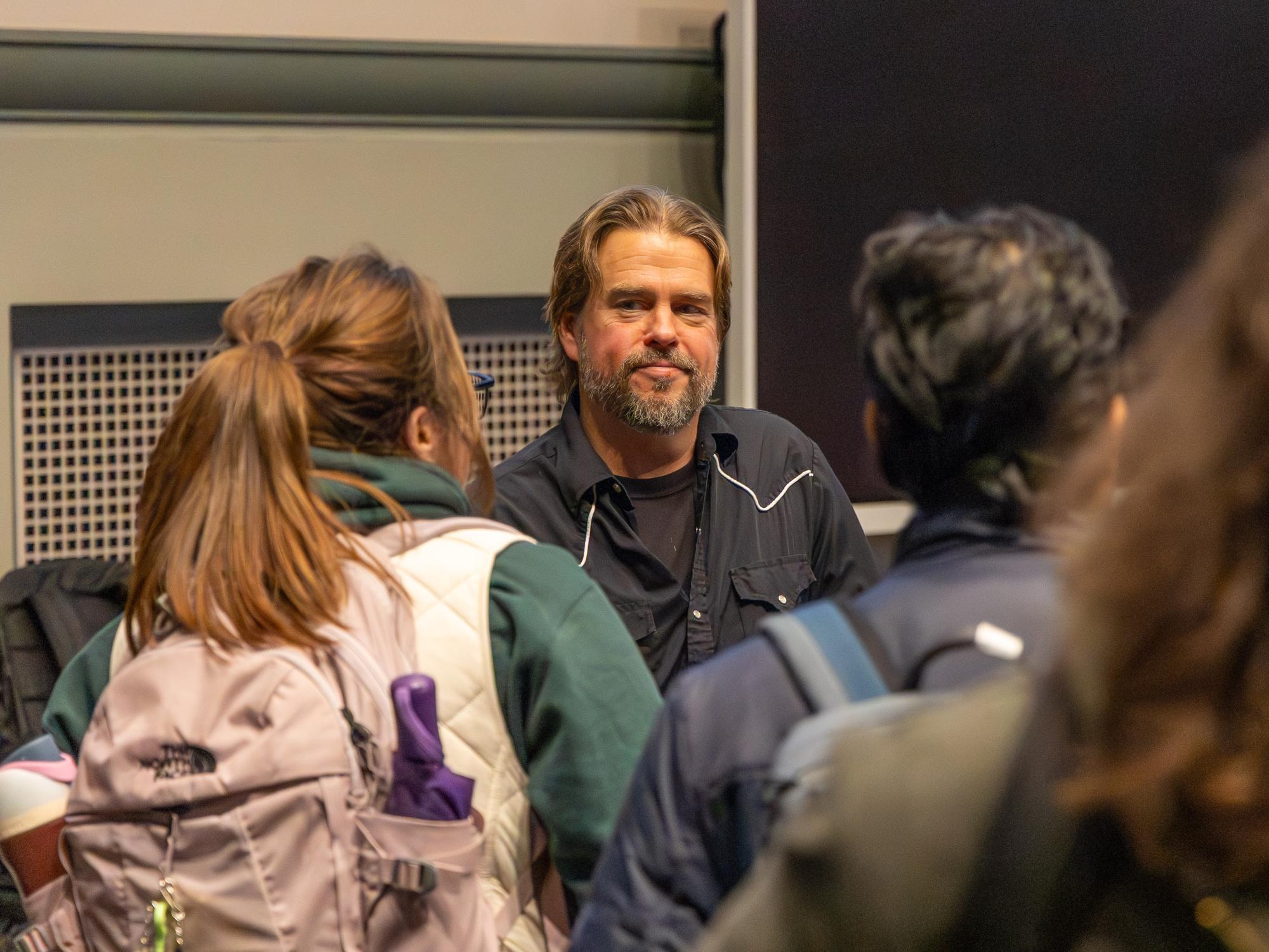Students gather around Kirk French