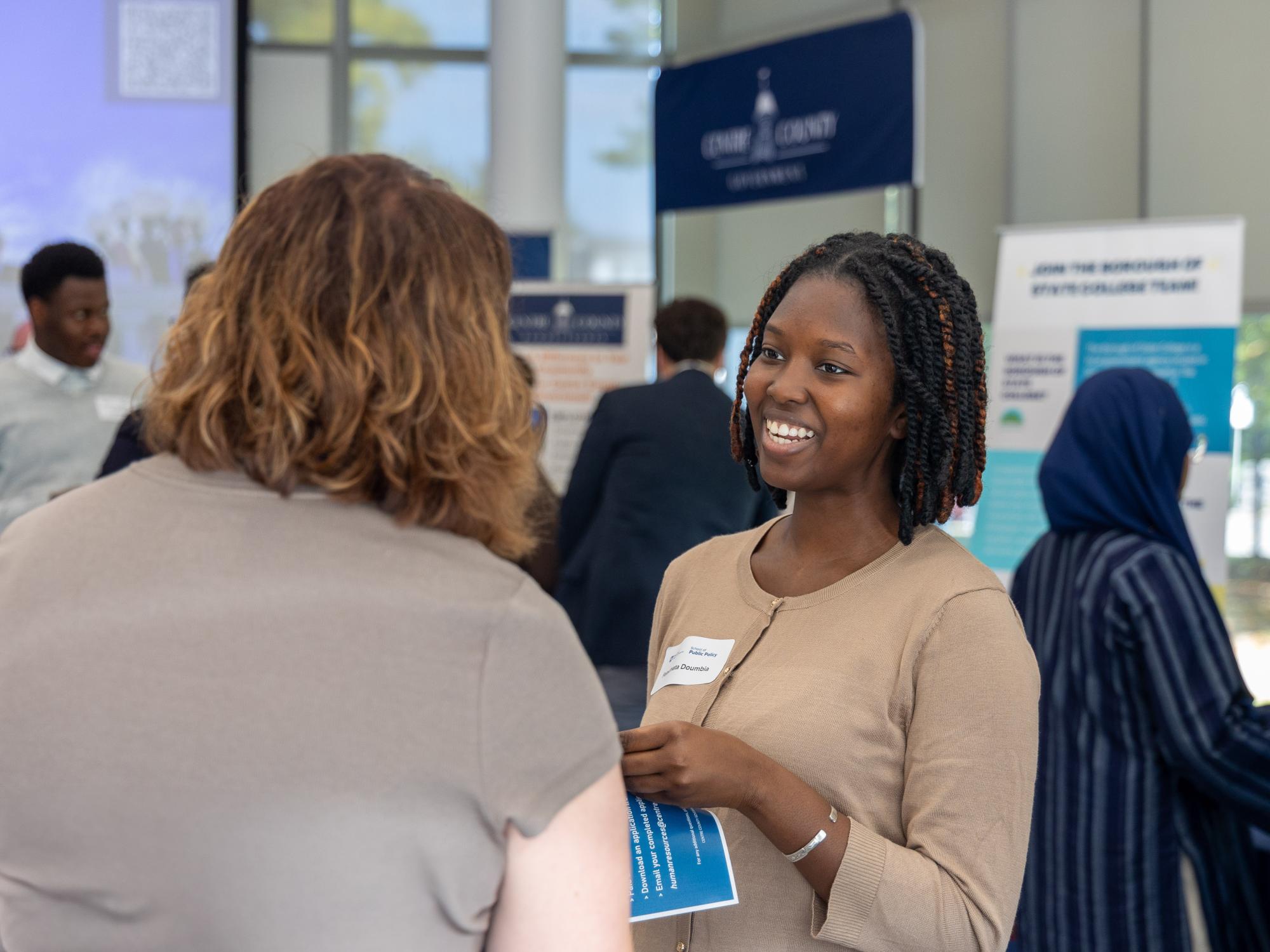 Fatoumata Doumbia speaks with Patton Township Manager Amy Farkas at the inaugural SPP Local Government Expo in Welch Building earlier this semester.