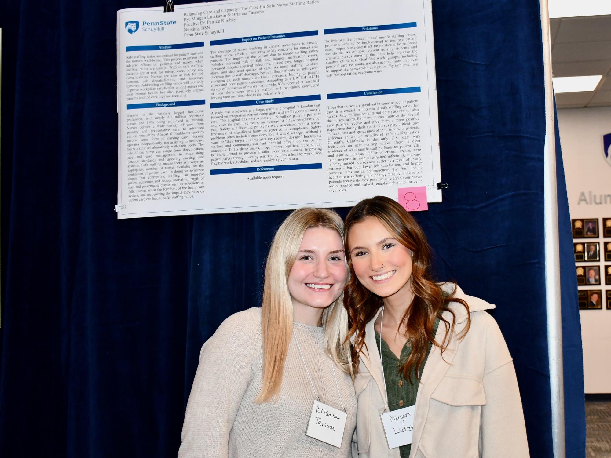 Two Schuylkill students stand next to their poster