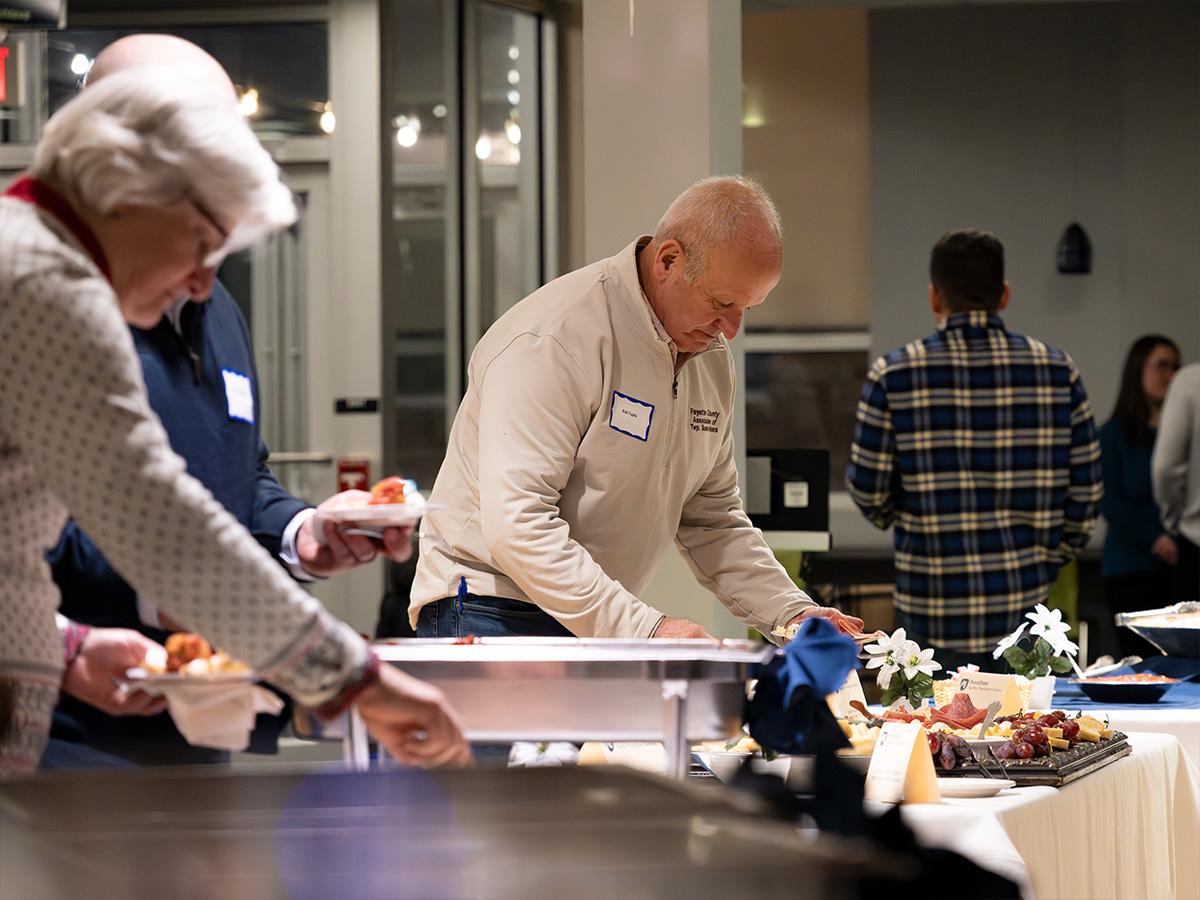 Visitors enjoy food provided by The Historic Stone House Restaurant during the 60th anniversary event.
