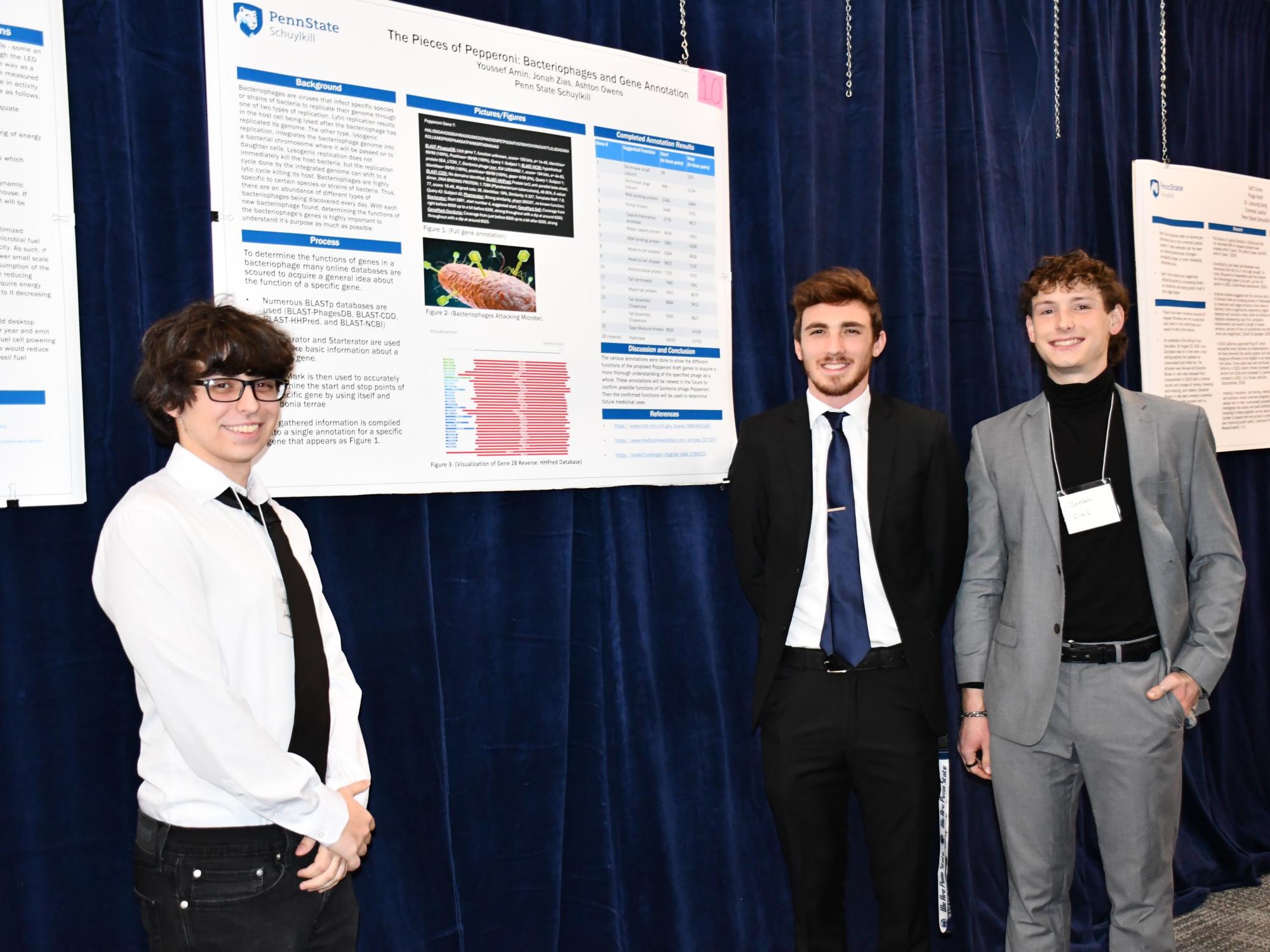 Three Schuylkill students pose with their poster