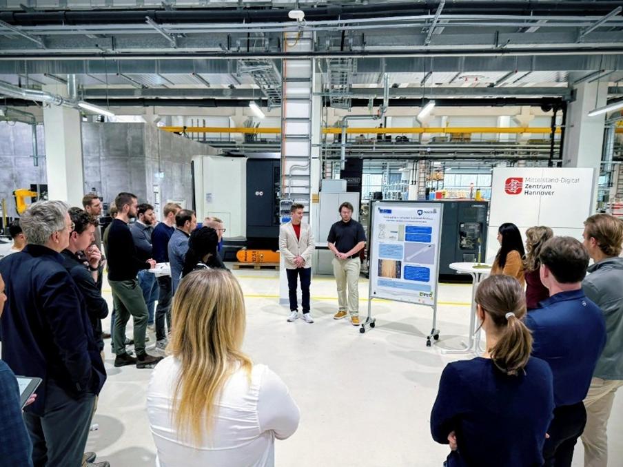 Two students presenting in front of an audience in a lab