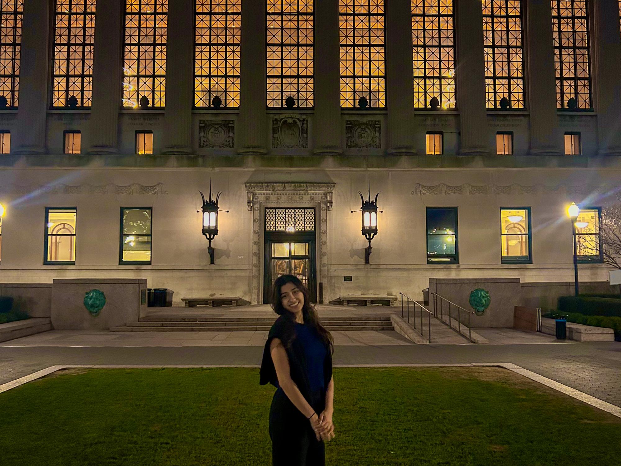 Vama Maniar stands outside the library at Columbia University. 