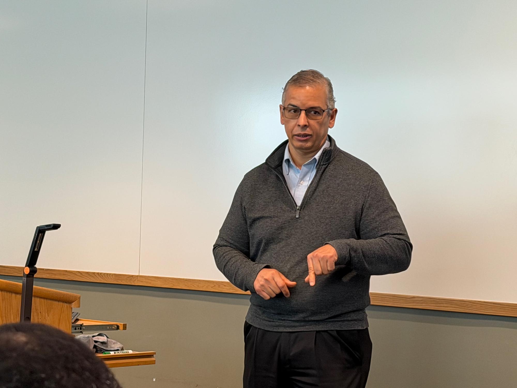 Pedro Robles standing in front of a room speaking.