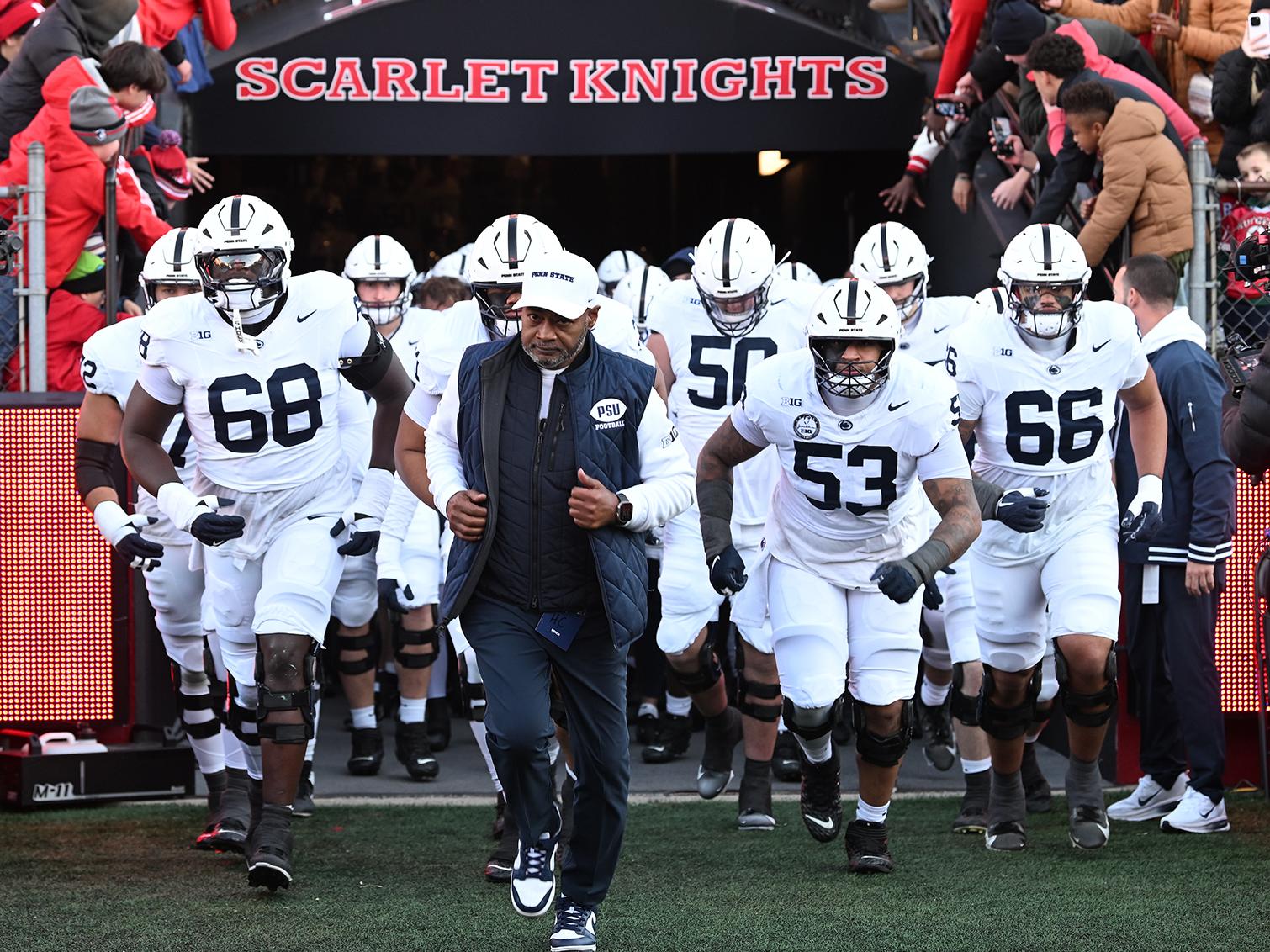 Coach leads team onto field