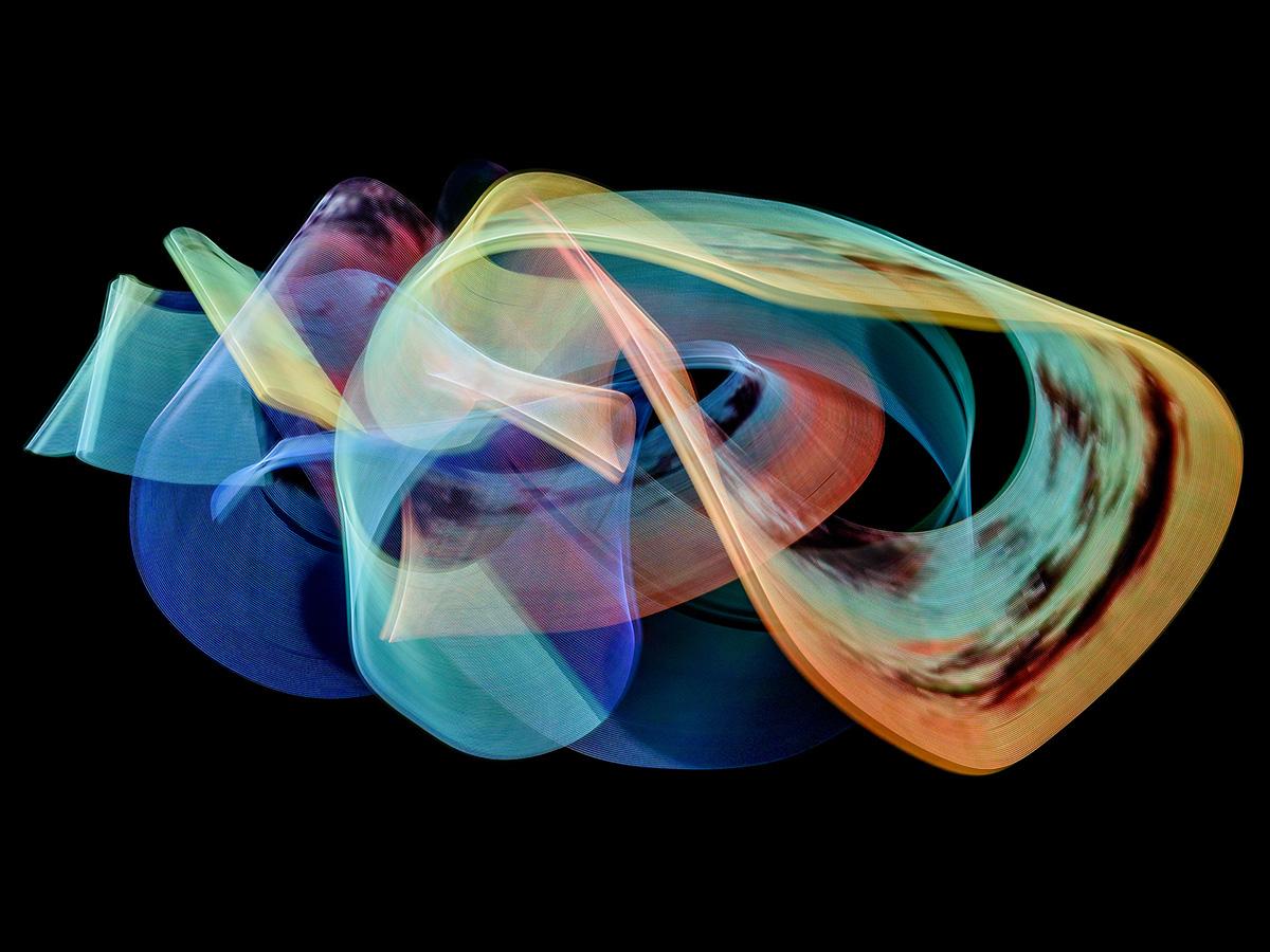 A multicolored abstract composition of looping light ribbons in blue, yellow, red and teal on a black background.