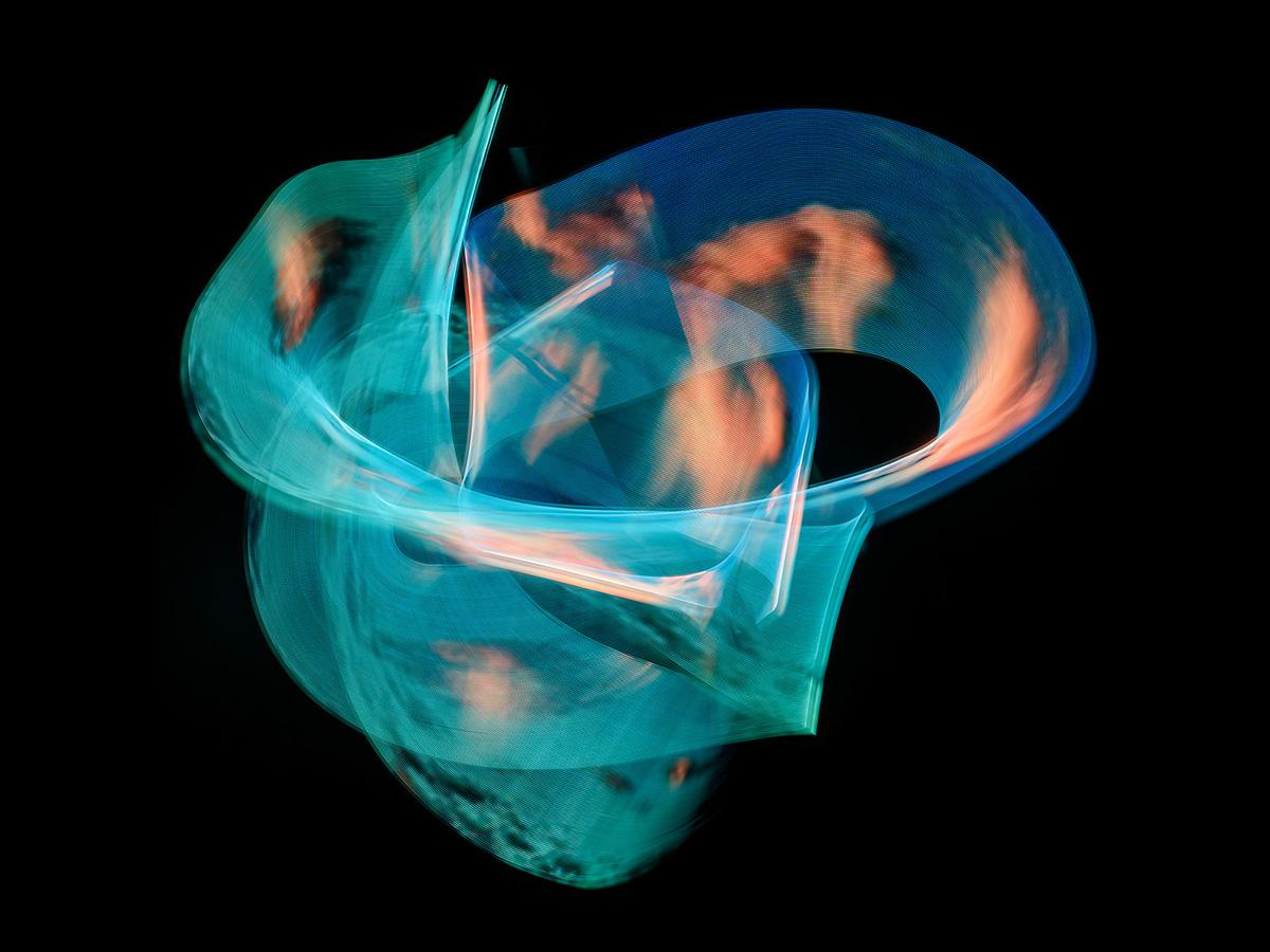 Intertwined teal and orange light trails forming a circular, layered structure against a dark background.