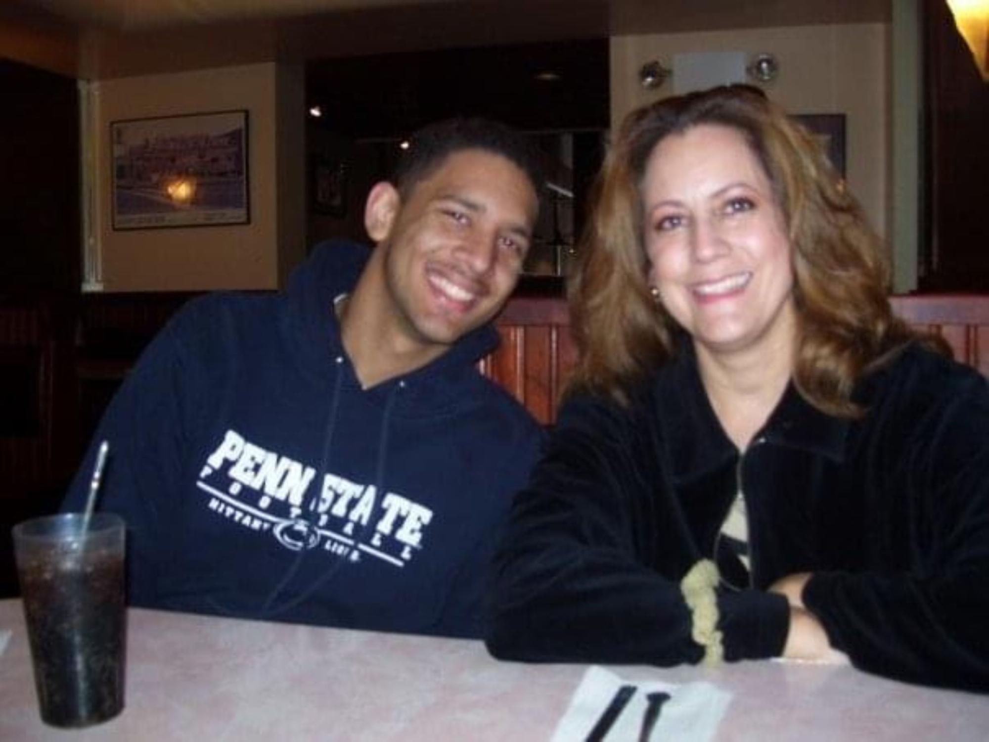 teen in penn state shirt at restaurant with mother
