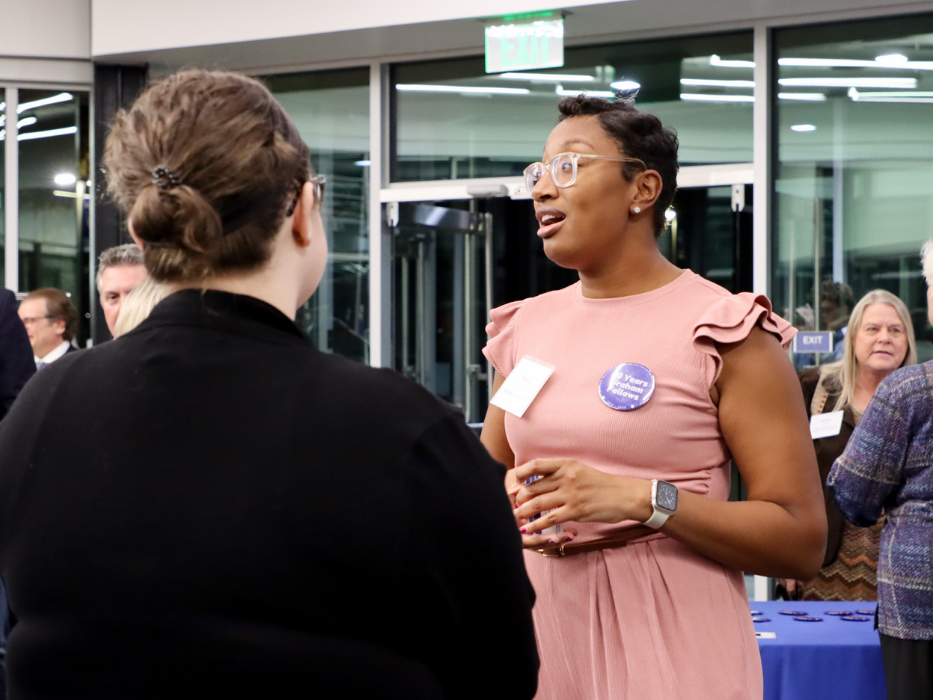 TaTyana Abreu talks to another woman at a networking event in the Graham Center