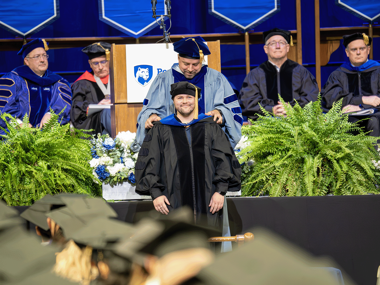 Emerson Waite being hooded at the fall 2025 Fox Graduate School commencement ceremony