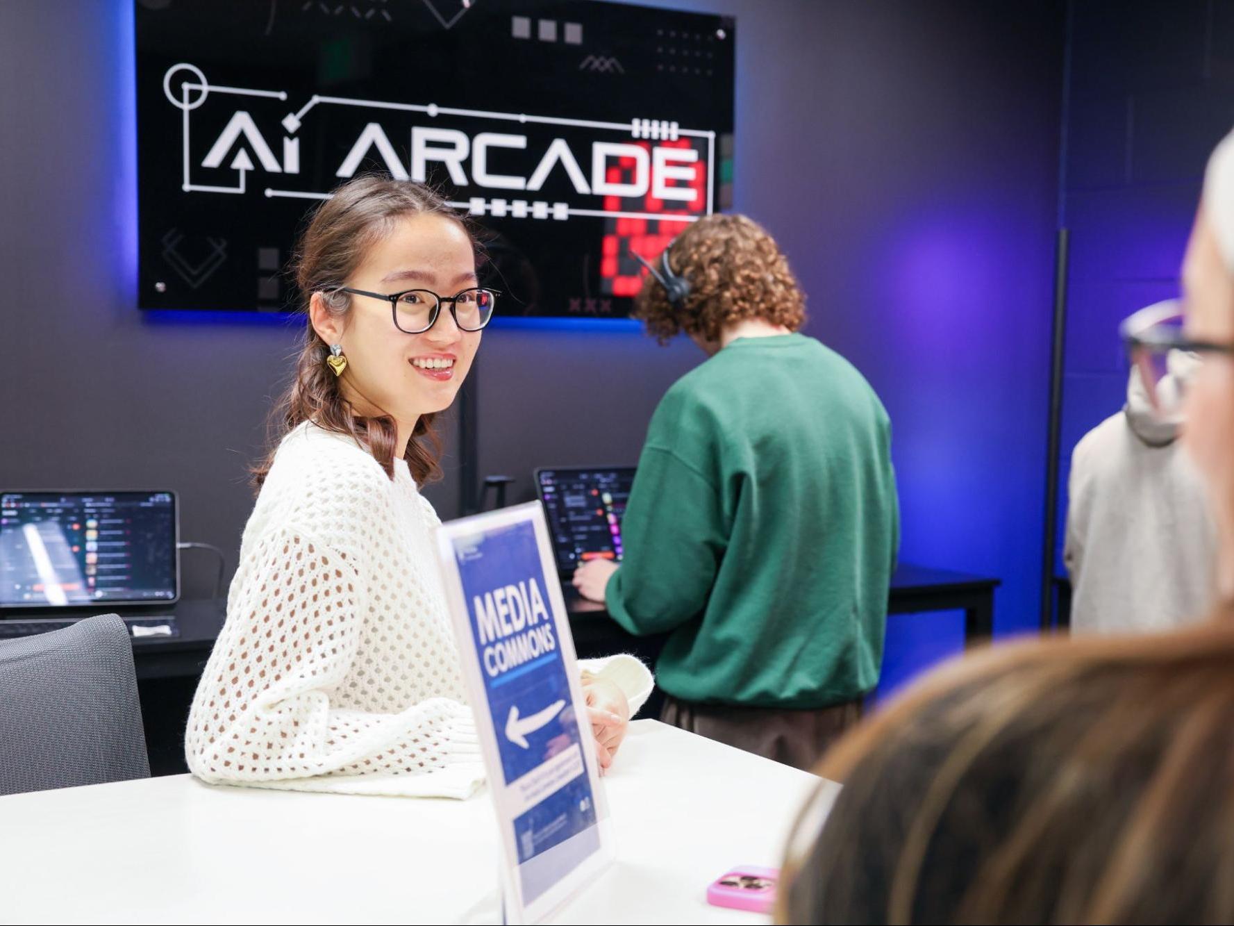 Aruzhan Yegemberdi, STAR member, walks students through the AI Arcade in the Shields Media Commons.
