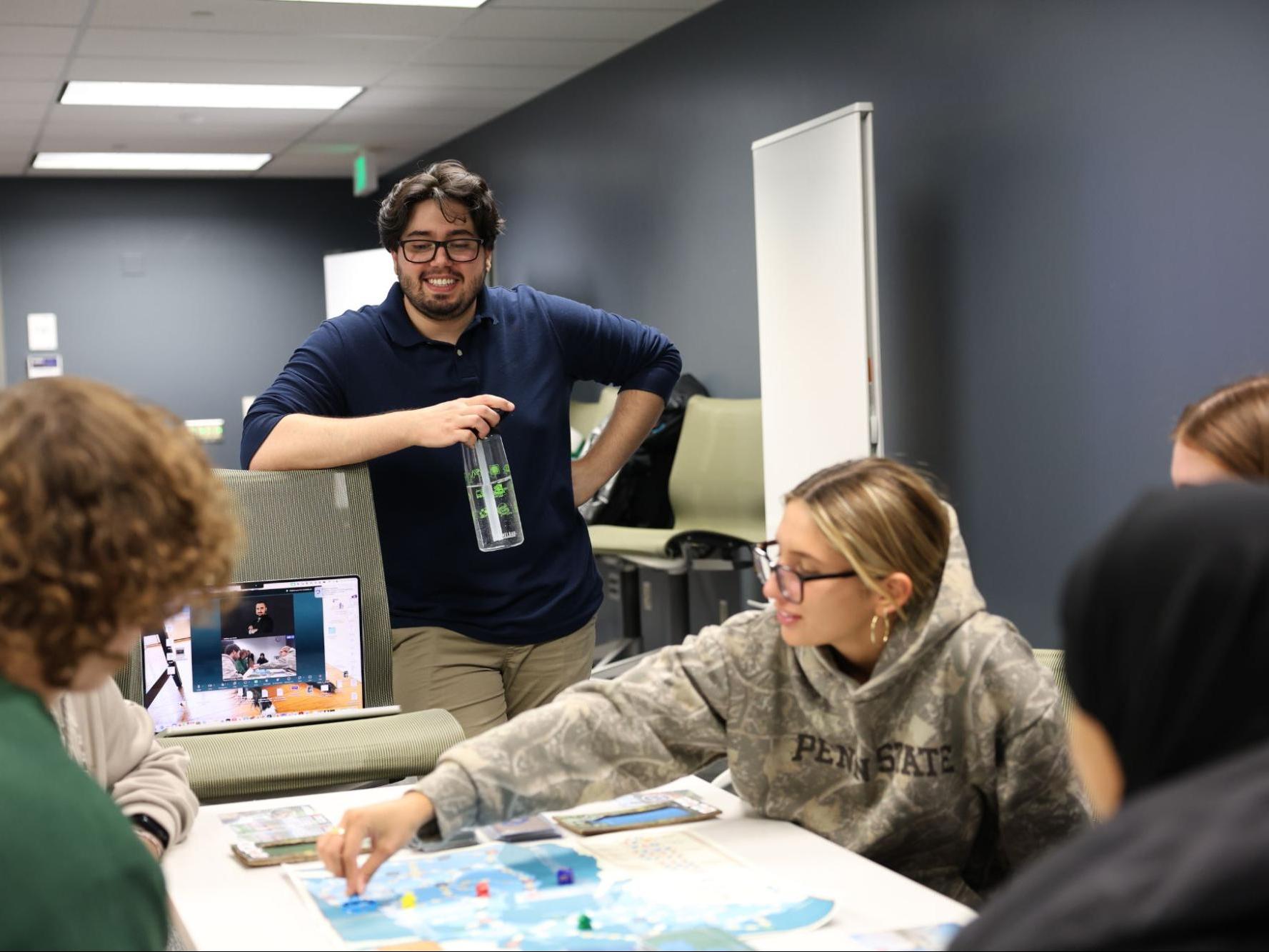 Andrea Barolo, STAR member, leads a playtest session for one of his board games, for both in-person and virtual attendees. 