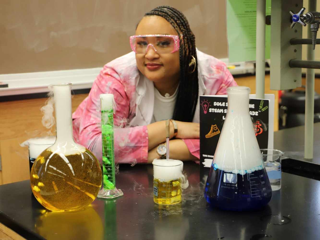 Jakyra Simpson poses in front of chemistry equipment