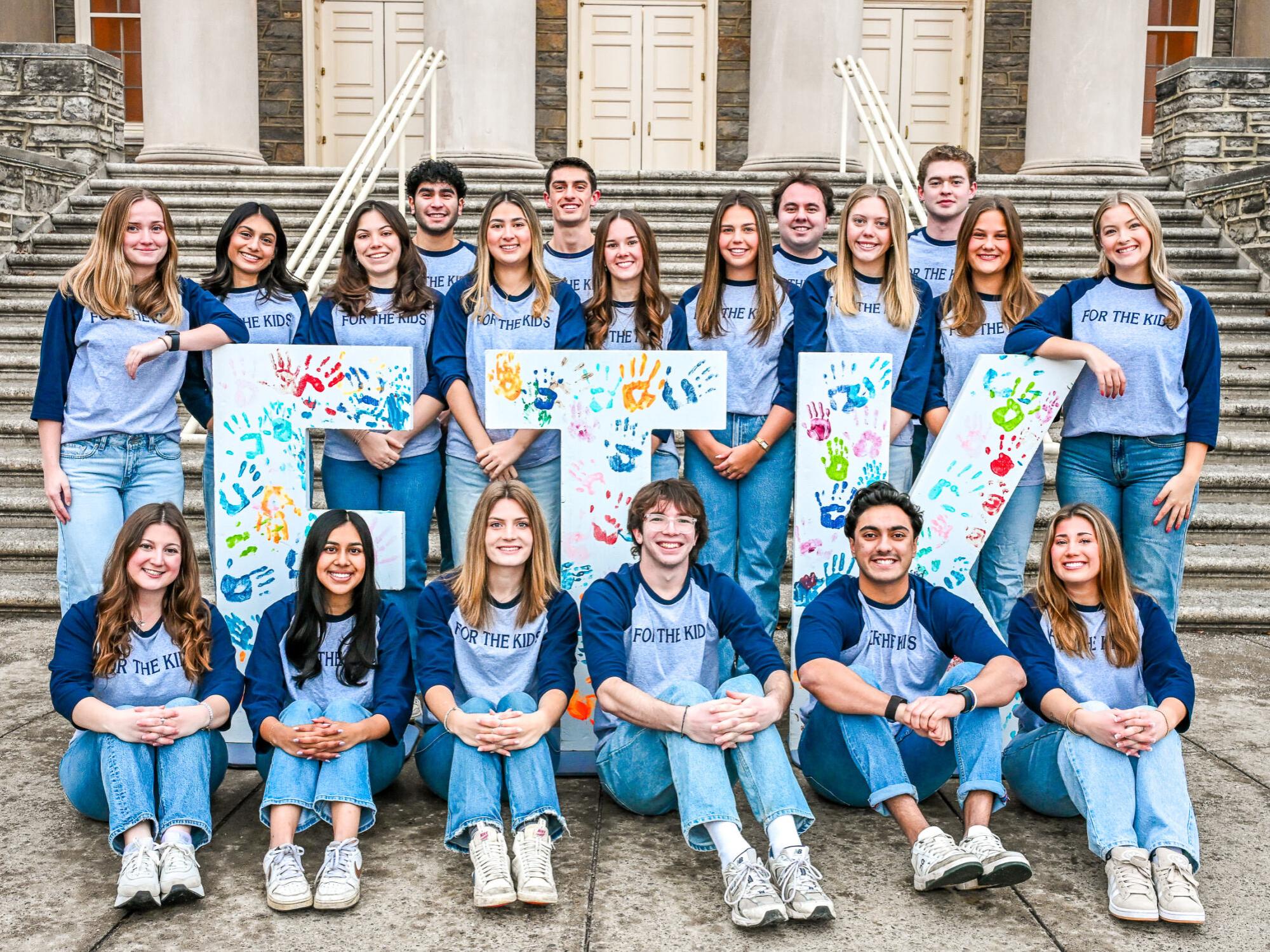 The THON directors stand in two rows, in front of Old Main.