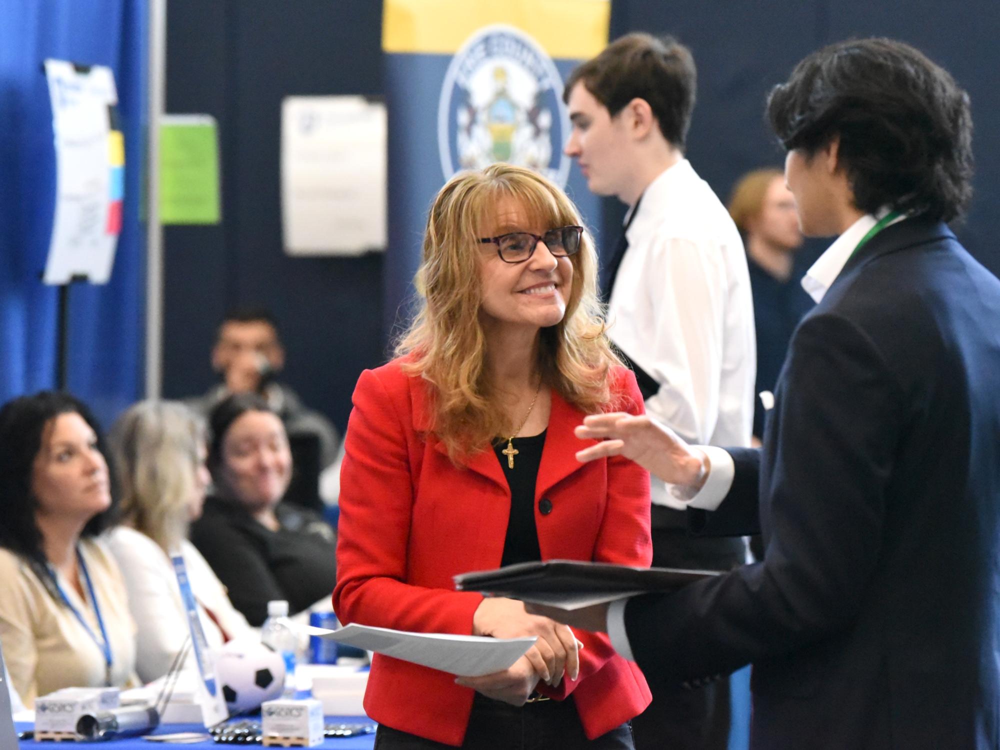 A student talks to a corporate recruiter at Penn State Behrend's spring career fair.