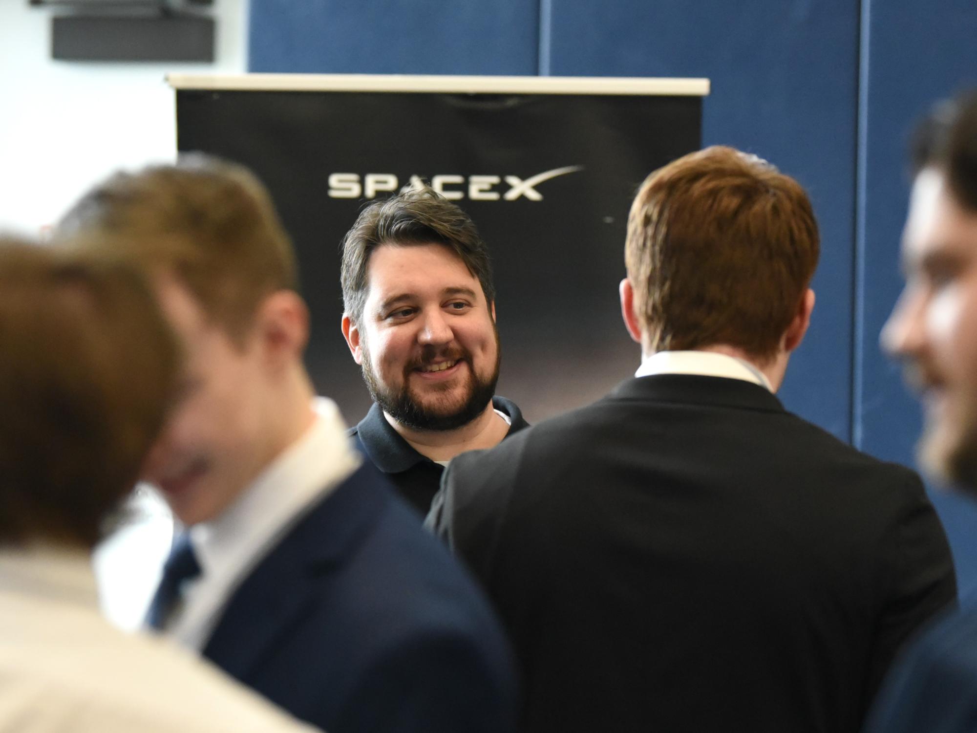 A recruiter for SpaceX talks with students at Penn State Behrend's spring career fair.