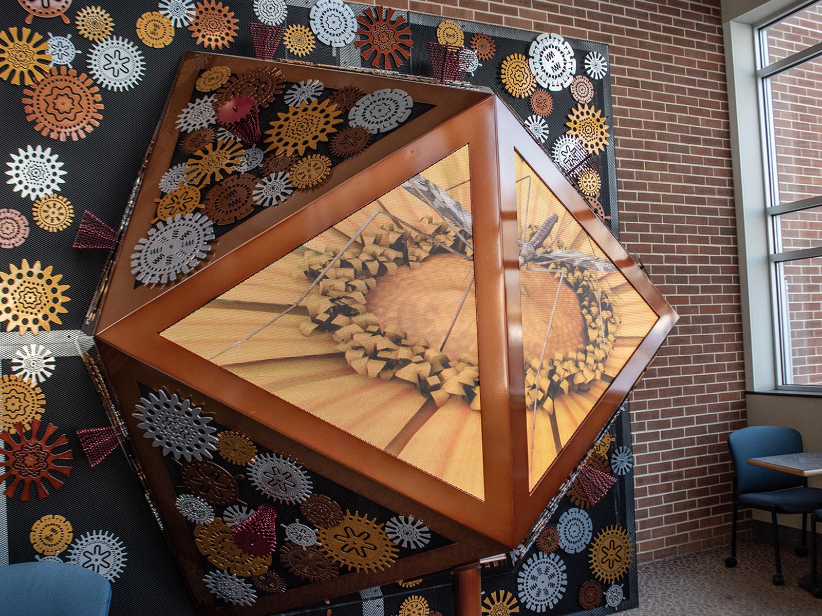 Biomachine, an aluminum sculpture featuring LED screens showing virus visualizations