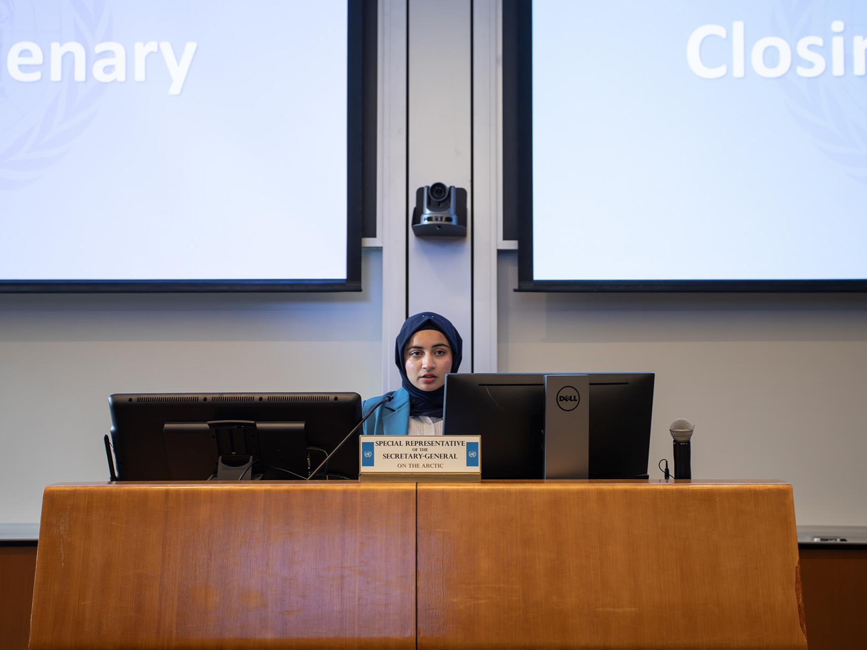 SIA student Zahaab Rehman speaks during the closing plenary session of the simulation.