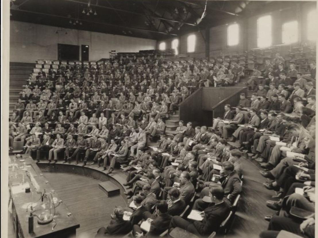 A black and white undated photo of students in a large lecture hall