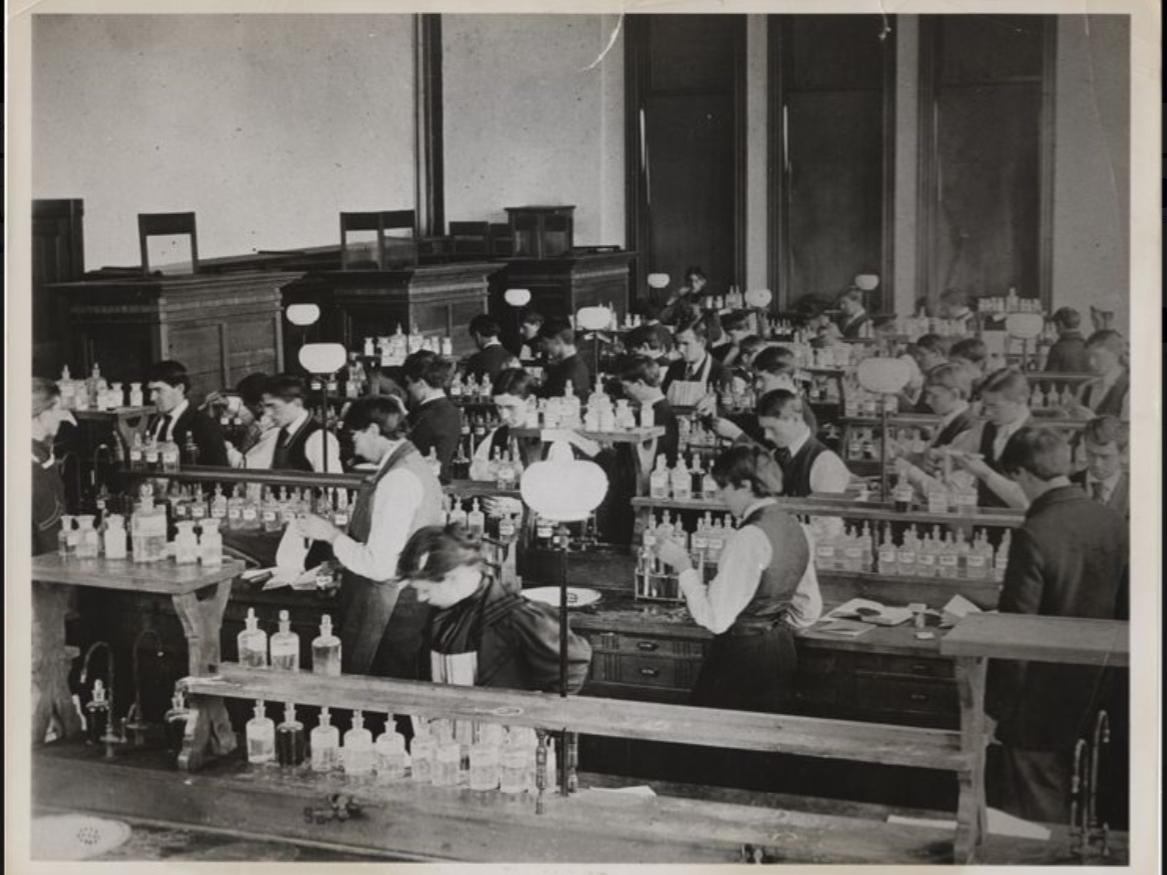 A black and white picture of students in a chemistry lab circa 1894