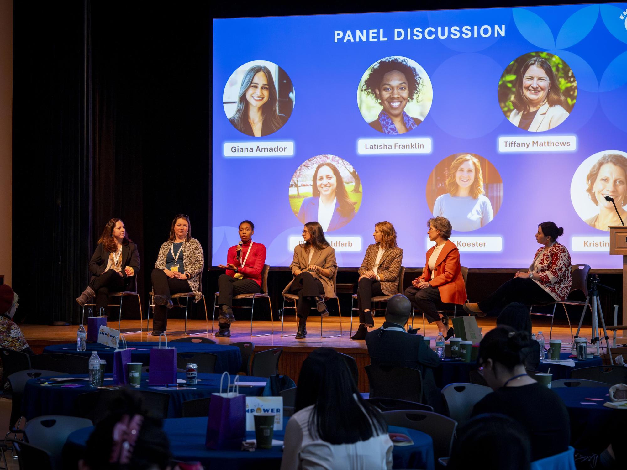 Group of speakers on stage presenting as part of a panel for the 2026 Empower Conference.