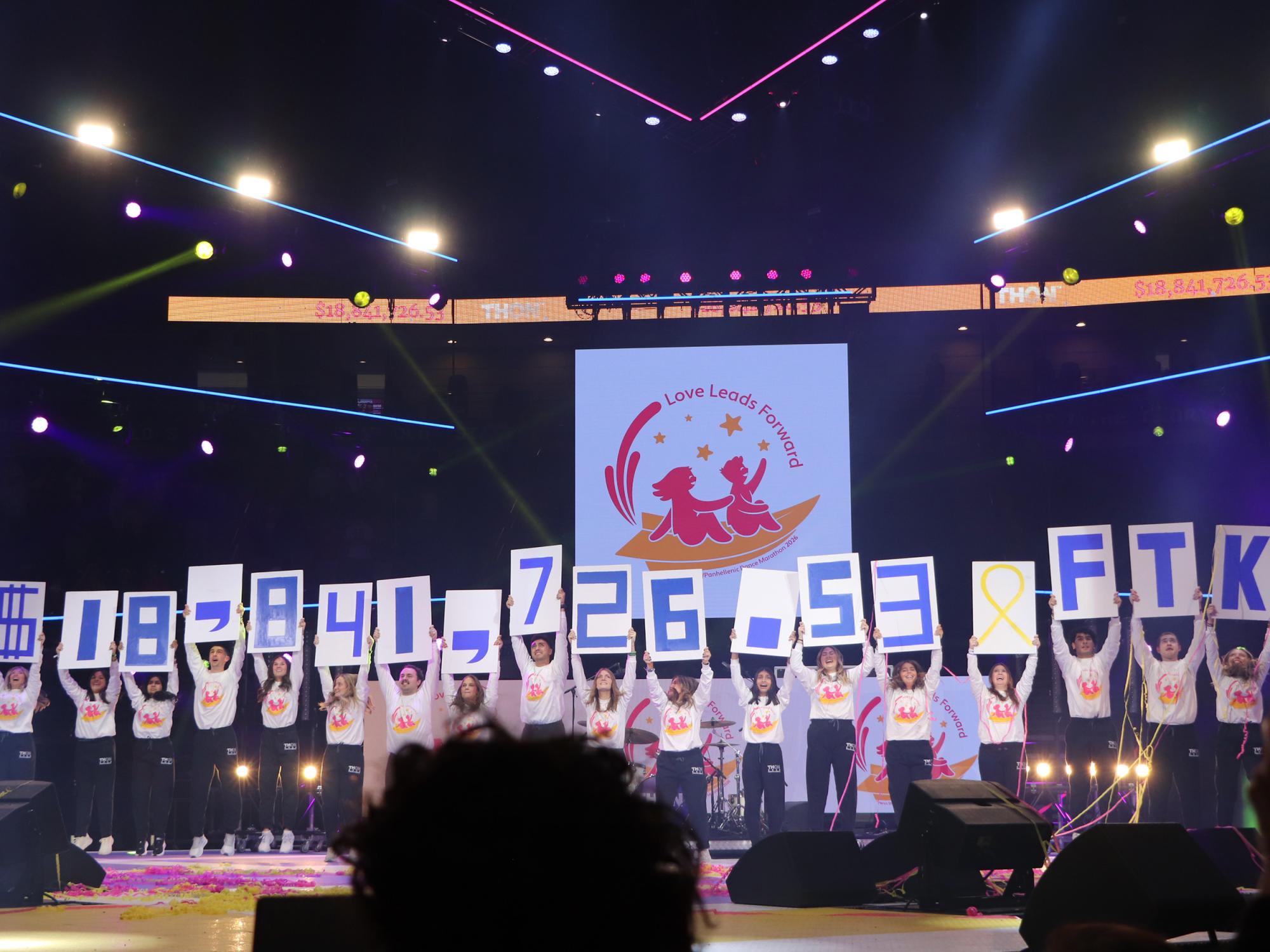 People stand in a line holding up numbers on posters.