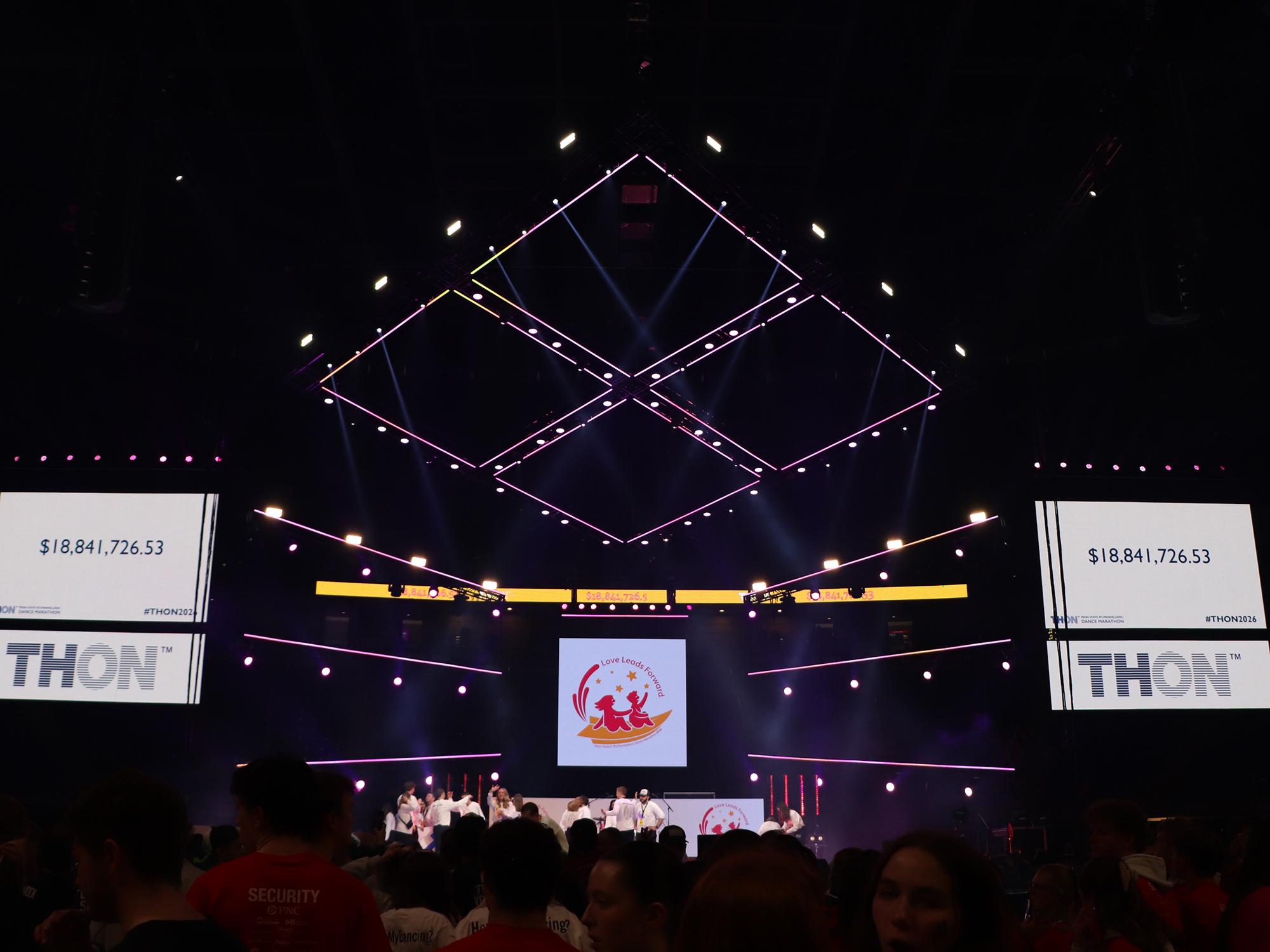 A dark arena with video screens.