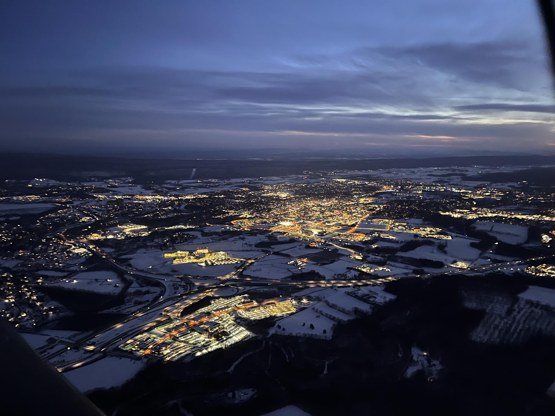 An aerial photo of a town at night. 