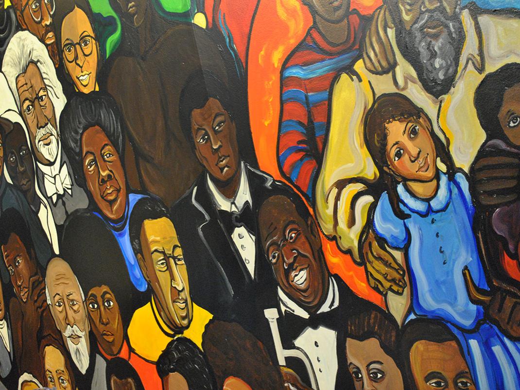 A mural depicting notable Black figures from American history, such as Martin Luther King and WEB Du Bois.