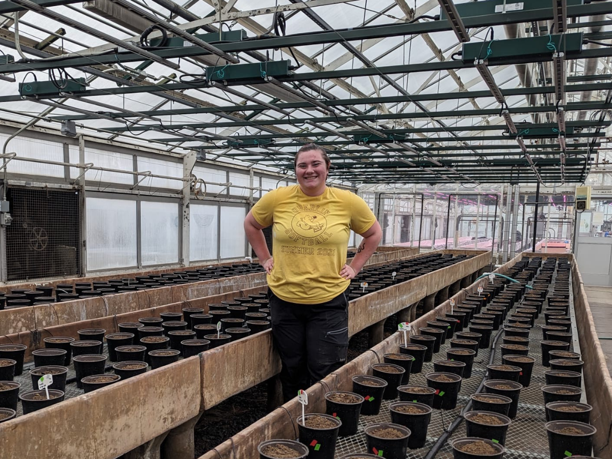 Sadie standing in a greenhouse