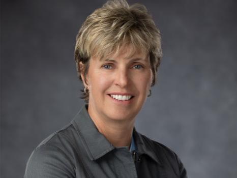 A head and shoulders photo of a smiling Renee DeMay