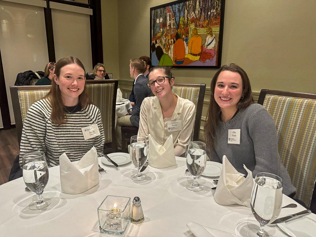 Avery Snowden, left, sits at a dinner table with two friends from the Presidential Leadership Academy.