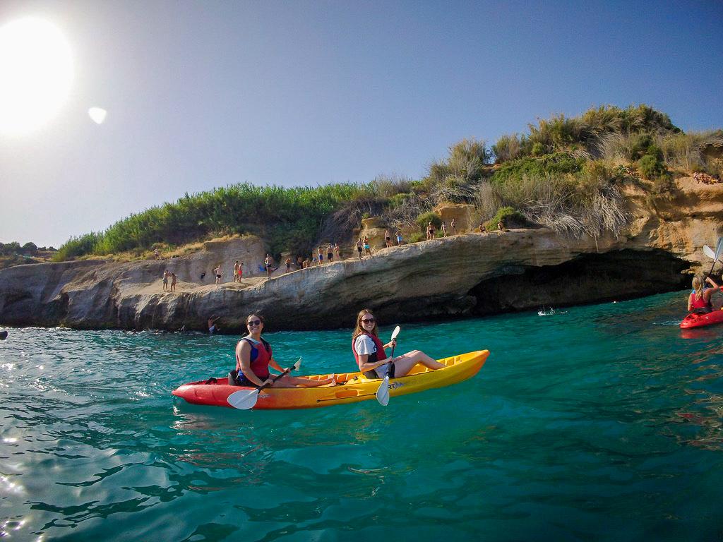 Avery Snowden, right, sits in a two-person kayak on the water with another Penn State student during her education abroad experience in Spain last summer.
