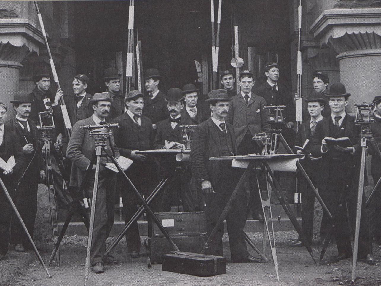 A black and white picture of students with surveying equipment in 1895