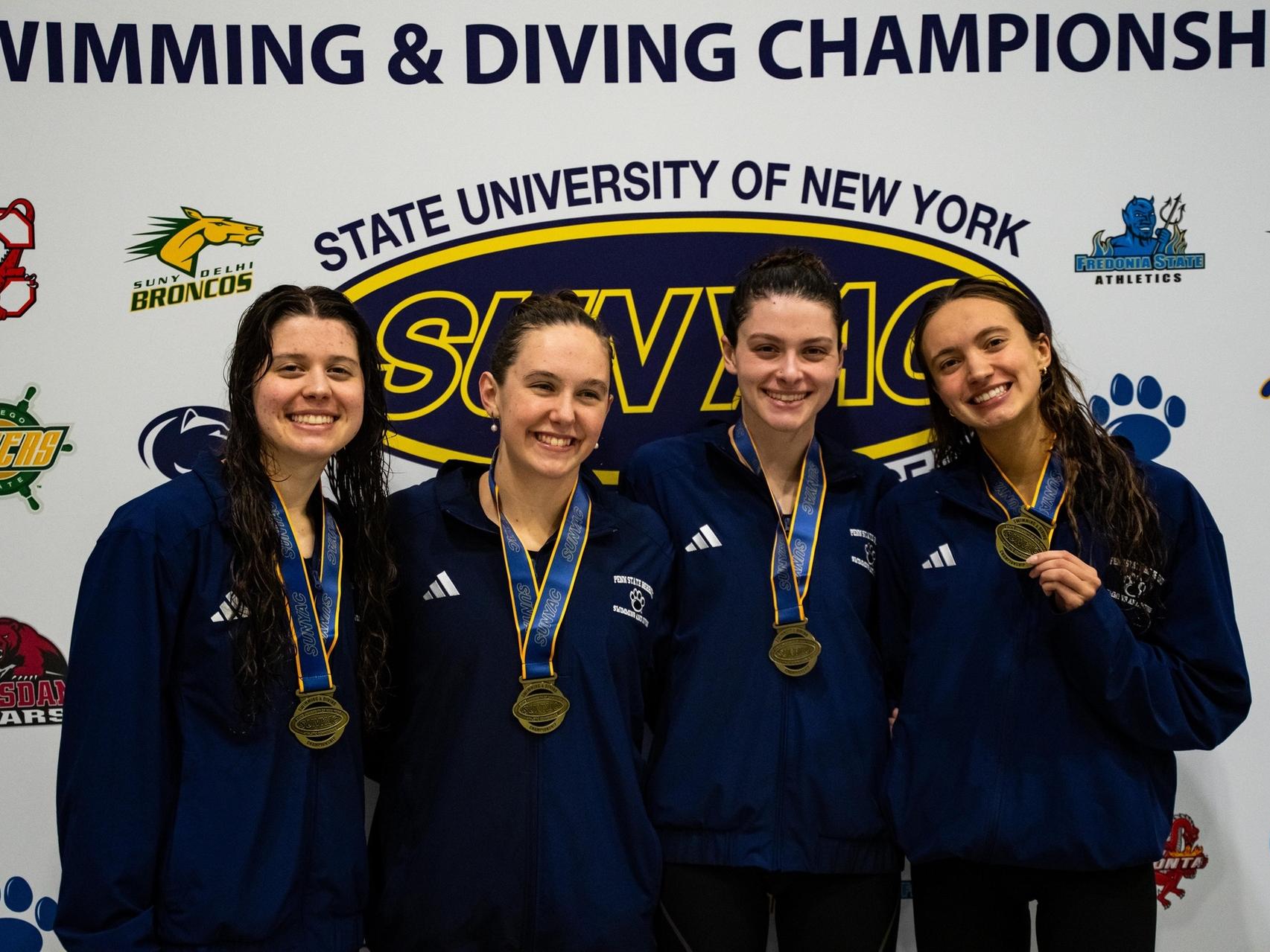Four members of the Penn State Behrend swimming and diving team hold their medals after the four-day tournament.