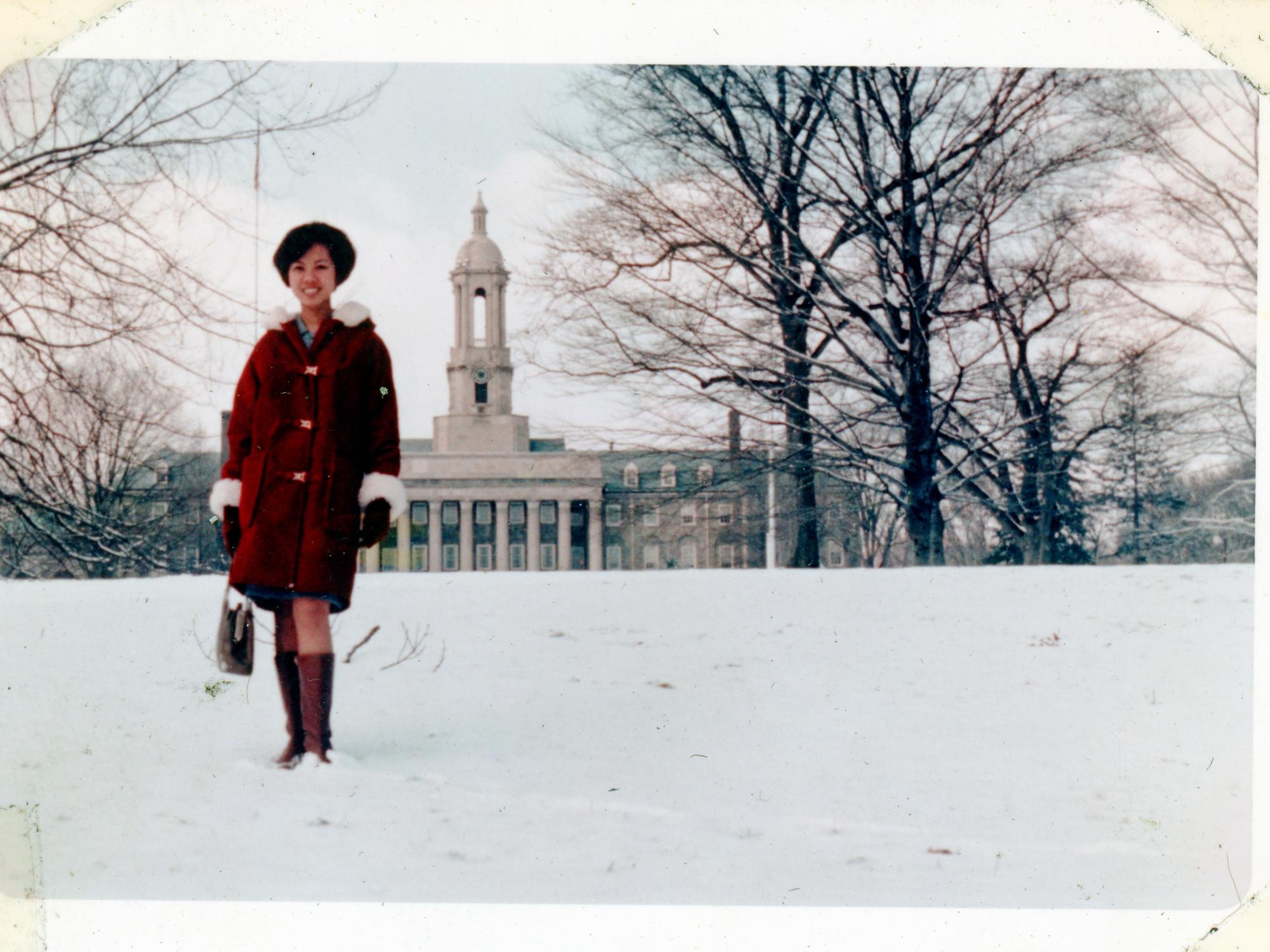 Vivian Valenty, Penn State Eberly College of Science alumna and founder of Dazzle Dry, standing in front of Old Main.